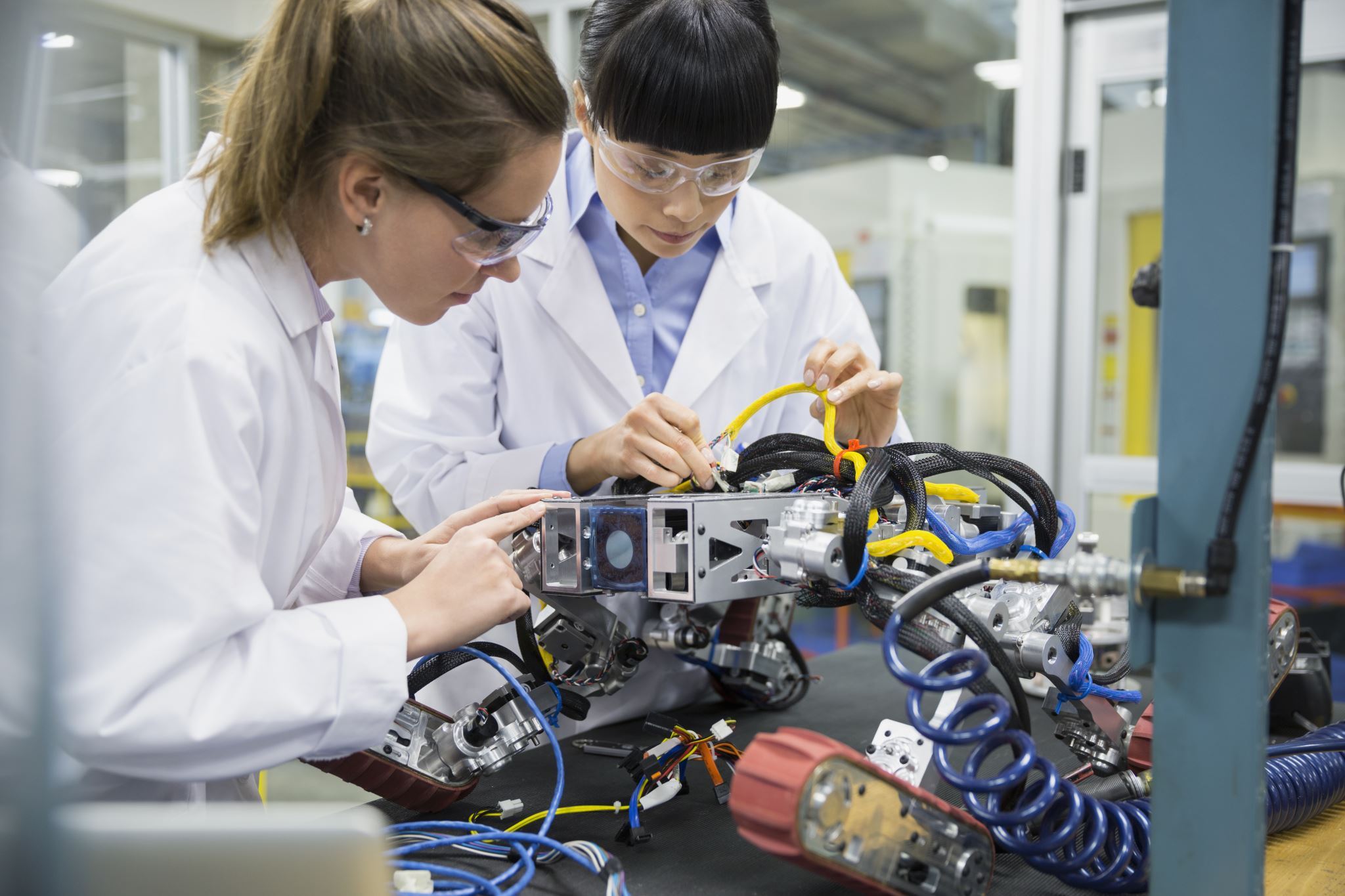 Engineers-assembling-robotics-in-factory